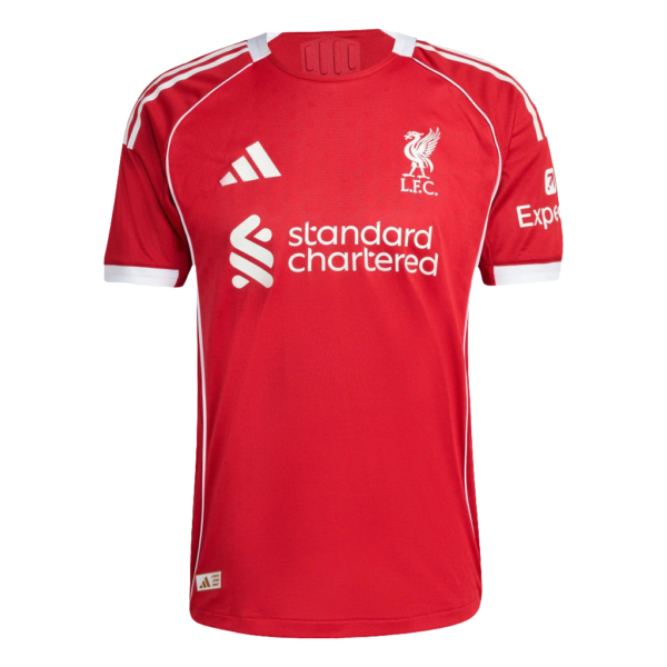 Red Liverpool FC home jersey with white piping, crest, Adidas logo, and Standard Chartered sponsor on the chest.