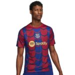 Young man wearing a blue and red FC Barcelona jersey with a yellow Spotify logo on the chest; crest near the collar.