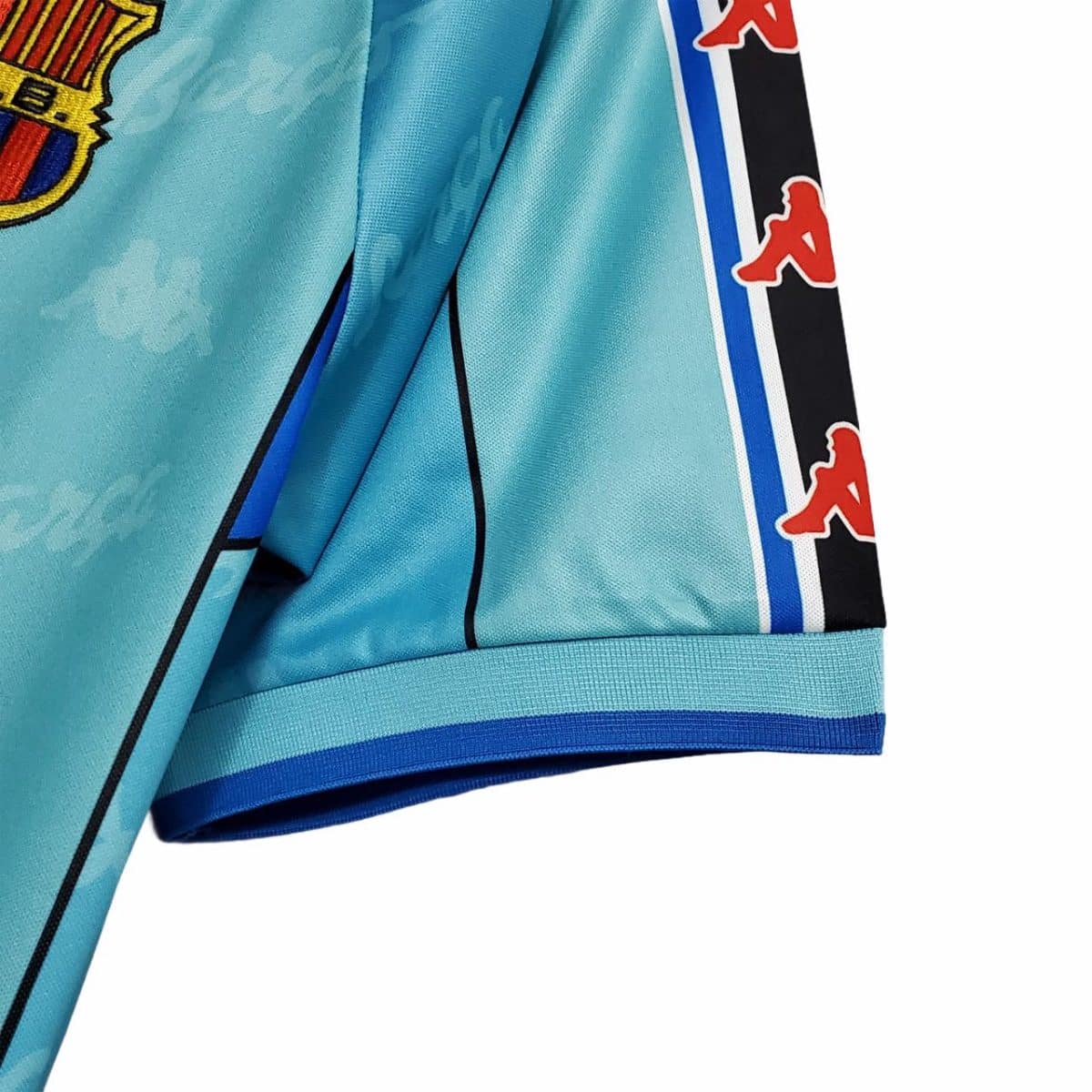 Close-up of a turquoise sports jacket sleeve with a patterned blue/black stripe and red Kappa logos along the side edge