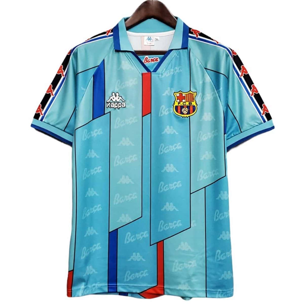 Light blue Barcelona football jersey with geometric panels, Kappa logos, and F.C.B. crest on the chest.