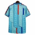 barcelona-away-classic-199697-jersey-with-ronldo-9-389263 | UAE SPORT STORE Back view of a turquoise Barcelona football jersey with geometric panels, Kappa logos, and red/blue vertical accents on sleeves and chest edge.
