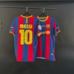 Two FC Barcelona jerseys hanging on hangers, blue and red vertical stripes; one shows 'MESSI 10' on the back, the other features the Barca crest and patches.