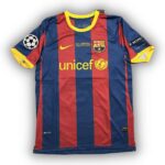 Barcelona FC jersey with UNICEF sponsor, blue and red vertical stripes, yellow Nike swoosh, club crest, and UEFA badge on the sleeve.