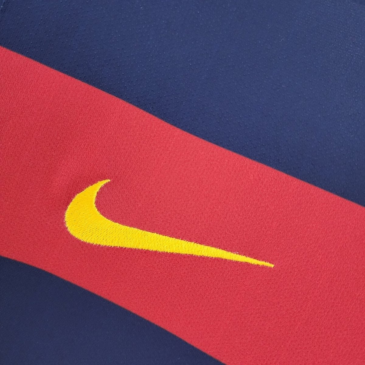 Close-up of blue and red fabric in a diagonal layout with a partial yellow curved line visible at the edge.