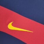 barcelona-classic-201516-final-with-messi-10-badges-jersey-491035 | UAE SPORT STORE Close-up of blue and red fabric in a diagonal layout with a partial yellow curved line visible at the edge.