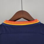 barcelona-classic-201516-final-with-messi-10-badges-jersey-521750 | UAE SPORT STORE Blue garment on a wooden hanger with a bright red-yellow striped collar visible at the top edge.