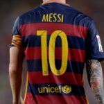 Back view of Lionel Messi wearing FC Barcelona jersey number 10, with yellow name and digits on blue and red stripes and a UNICEF logo on the lower back.