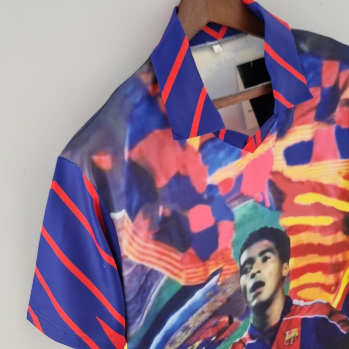 Close-up of a blue fabric with red diagonal stripes and a colorful abstract print.