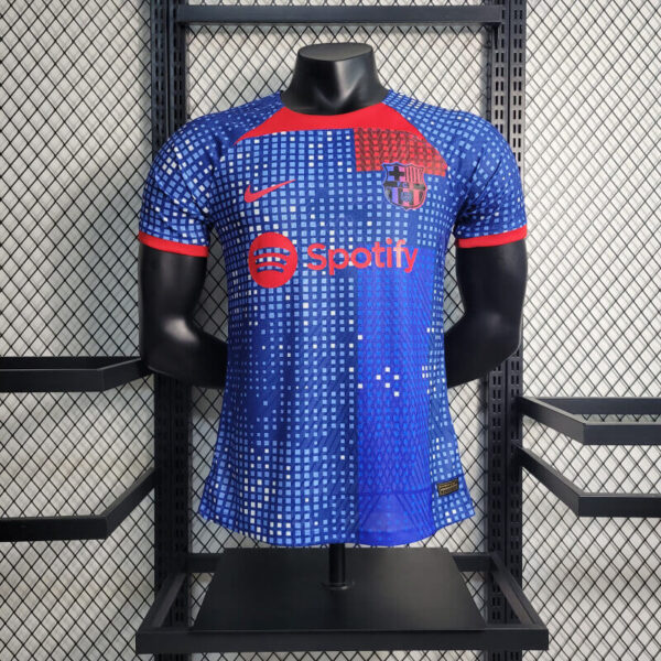 Blue FC Barcelona soccer jersey on a mannequin in a store, featuring the red Spotify logo across the chest.