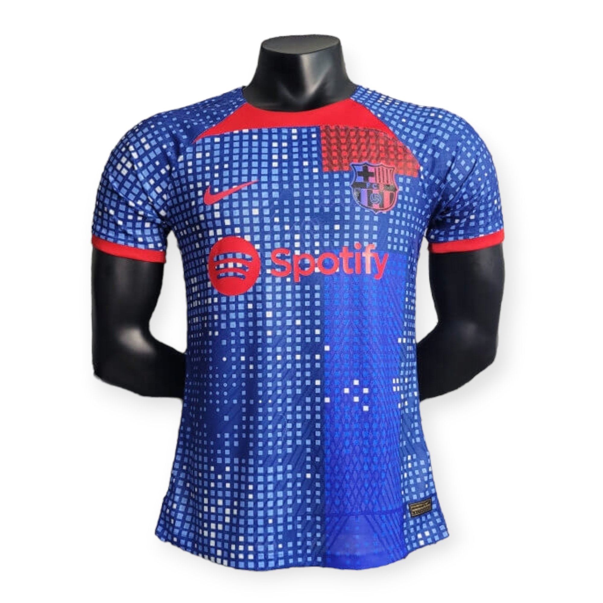 barcelona-special-edition-jersey-202324-715798 | UAE SPORT STORE Mannequin wearing a blue FC Barcelona soccer jersey with a pixelated pattern and Spotify logo on the chest.