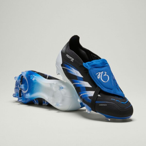 Black and blue football boot with white accents and laces, positioned on a pale background, showing the sole and branding.