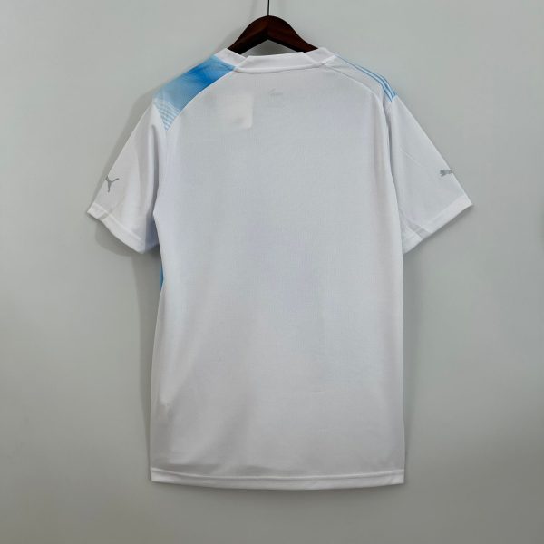 White athletic jersey on a hanger with light blue shoulder accents, viewed from the back