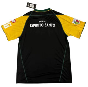 Back of a black sports jersey with yellow sleeves, showing the sponsor 'Banco Espirito Santo' and patches on the sleeves.