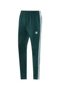 Dark green Adidas track pants with white side stripes and zip pocket on the right hip