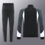 Black and gray color-block tracksuit: pants with gray side panels and a matching long-sleeve top with white accents on the sleeves and back.