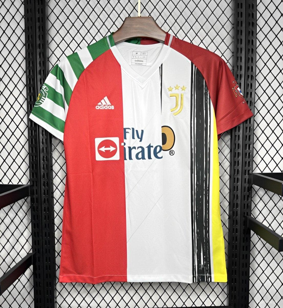 bea63e93b6342e9ac5df05d9 | UAE SPORT STORE Colorful Juventus football jersey on a hanger with red left panel, white center, green striped sleeve, and a black brushstroke stripe on the right with yellow trim.