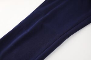 Close-up of dark navy fabric with a diagonal seam and fold details.