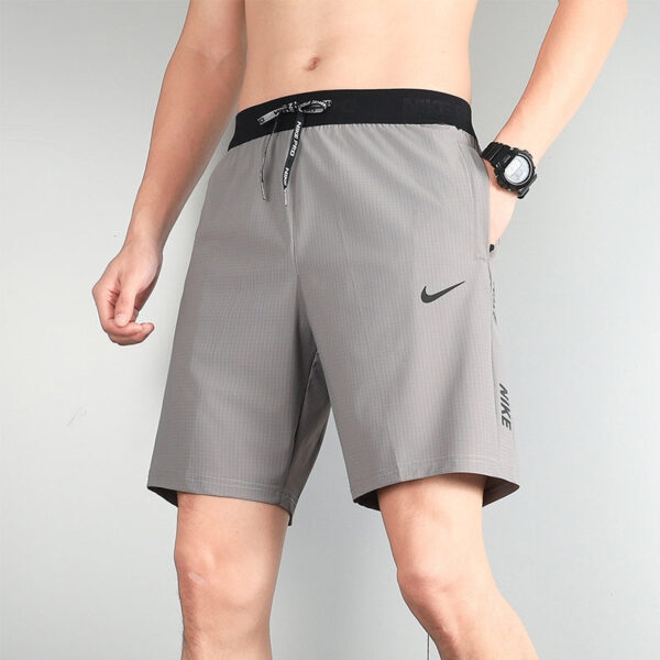 Men's gray Nike athletic shorts with black waistband and adjustable drawstring, side swoosh logo visible.