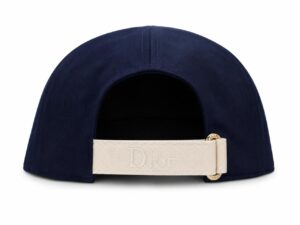 Navy curved-back cap viewed from the rear with a beige strap embossed with 'Dior' seen at the back.