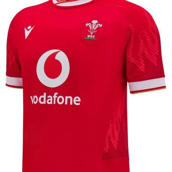 Front view of a red Wales Rugby Union jersey with Vodafone sponsor and WRU crest on the chest, white collar trim.