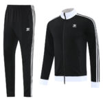 Adidas black track suit with white stripes on sleeves and down pant legs, shown with a matching black jacket featuring a white collar and cuffs and small Adidas logo.
