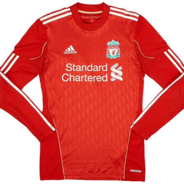 Red Liverpool FC home jersey with white Adidas logo and crest, sponsor text 'Standard Chartered' across the chest (front view).