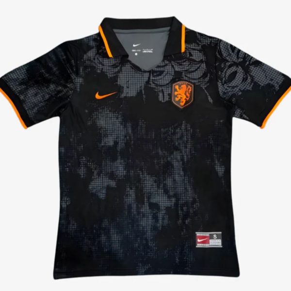 Black Netherlands football jersey with orange lion crest, orange Nike swoosh, and orange-trimmed sleeves on a dark abstract pattern.