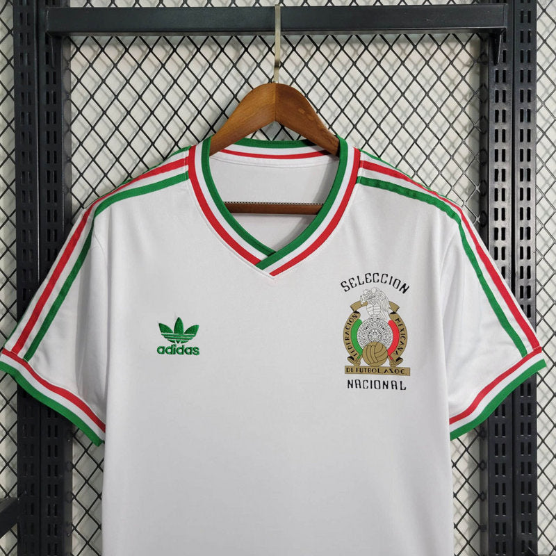 big-136_7656b361-75d0-4081-a40b-ebd253d4bcbd | UAE SPORT STORE White Adidas soccer jersey on a hanger with green logo on the left chest and a 'Selección Nacional' crest on the right, red/green trim at collar and sleeves.