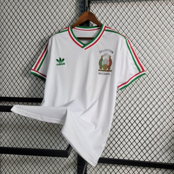 big-138-600x600_a108b55f-00bc-4a6f-b6e8-8533db5fb5c6 | UAE SPORT STORE White Mexico national team jersey on a hanger, featuring a green Adidas logo and red/green trim with the federation crest on the chest.