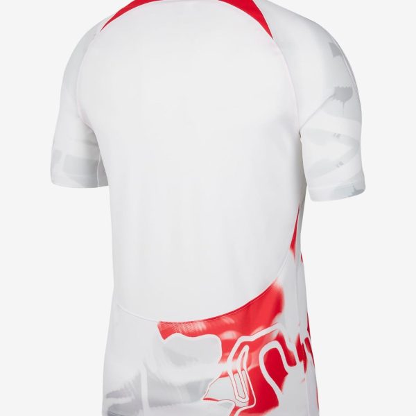 Back view of a white sports jersey with red collar trim and red graphic design along the lower back area, short sleeves visible.