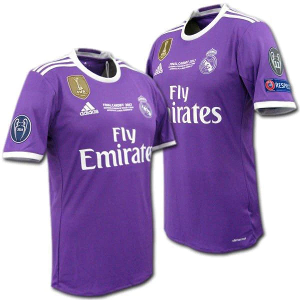 Two purple Real Madrid football jerseys shown side by side, front view, with white trim, Fly Emirates sponsor, and league badges on sleeves.