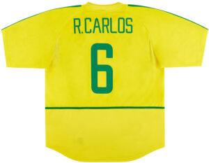 Back of a bright yellow sports jersey with green text reading 'R. Carlos' and the number 6 in green