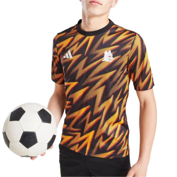 Athlete in a black, red, and yellow zigzag-pattern jersey holding a soccer ball against a white background.