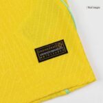 c021af2b-a182-4416-ac51-6455ef95bf65 | UAE SPORT STORE Close-up of bright yellow fabric with a black label reading 'ENGINEERED' and a serial code, showing a turquoise edge detail.