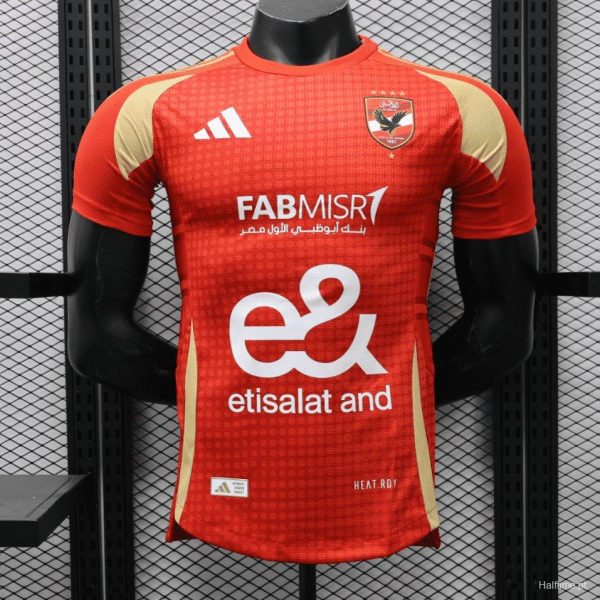 Red sports jersey on a mannequin, featuring a crest on the chest, Adidas logo, and the sponsor texts FAB MISR and etisalat.