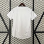 White short-sleeve shirt on a wooden hanger, displayed against a diamond-pattern metal grid backdrop, with subtle textured pattern on fabric.