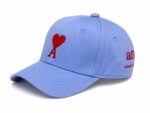 Blue baseball cap with red heart and "A" embroidery.