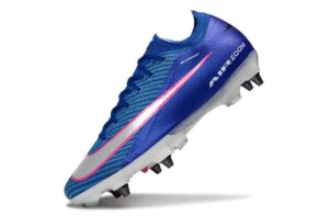Blue Nike soccer cleat with pink swoosh, studded white outsole, angled to show profile and traction studs