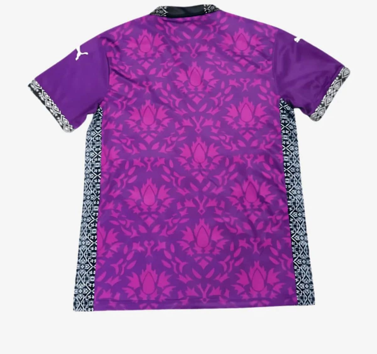 Purple tunic with pink floral/damask pattern and black-and-white geometric side panels visible along the sides.