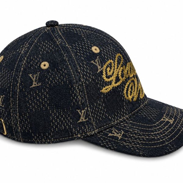 Denim baseball cap with gold LV lettering on the front and small LV monograms, featuring gold stitching and an adjustable back buckle.