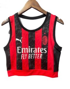 AC Milan red-and-black striped cropped jersey on a hanger, featuring the Emirates Fly Better sponsor and the club crest.