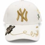 Yankees cap with gold embroidery and floral details, stylish accessory for sports fans.