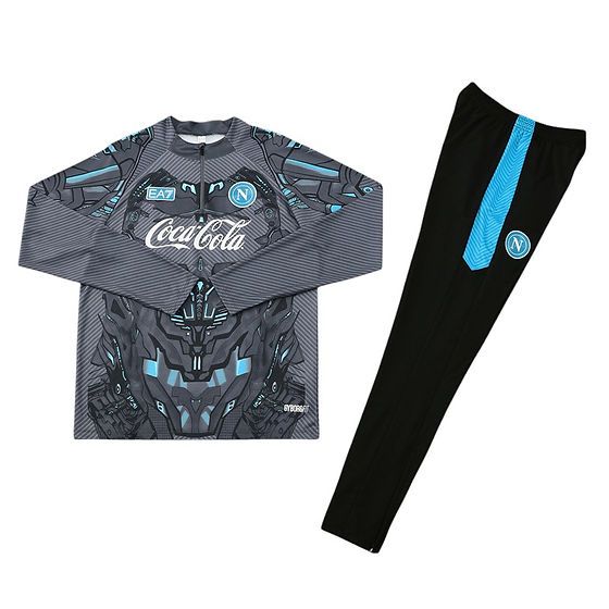 Napoli football training jersey with gray-blue geometric pattern and Coca‑Cola sponsor, club crest visible, paired with black track pants featuring a blue stripe and Napoli badge.