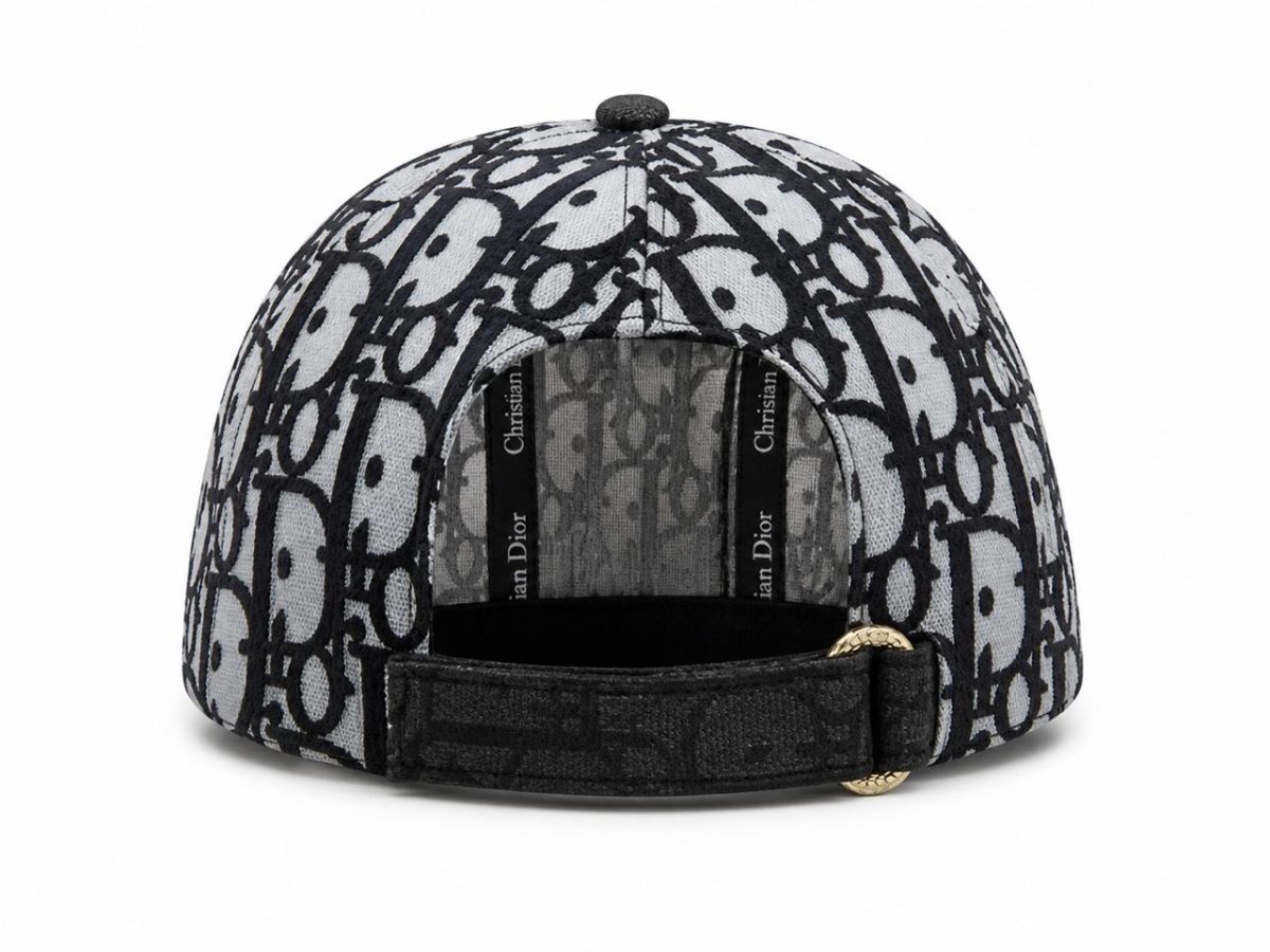 Back view of a gray and black Dior monogram baseball cap with an adjustable strap and gold-tone buckle at the rear.