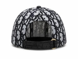 Back view of a gray and black Dior monogram baseball cap with an adjustable strap and gold-tone buckle at the rear.