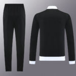 Black athletic tracksuit with elastic-waist pants and a long-sleeve top featuring white cuffs and hem.