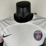 Gray Paris Saint-Germain soccer jersey on a black mannequin displaying the Nike swoosh and PSG crest.