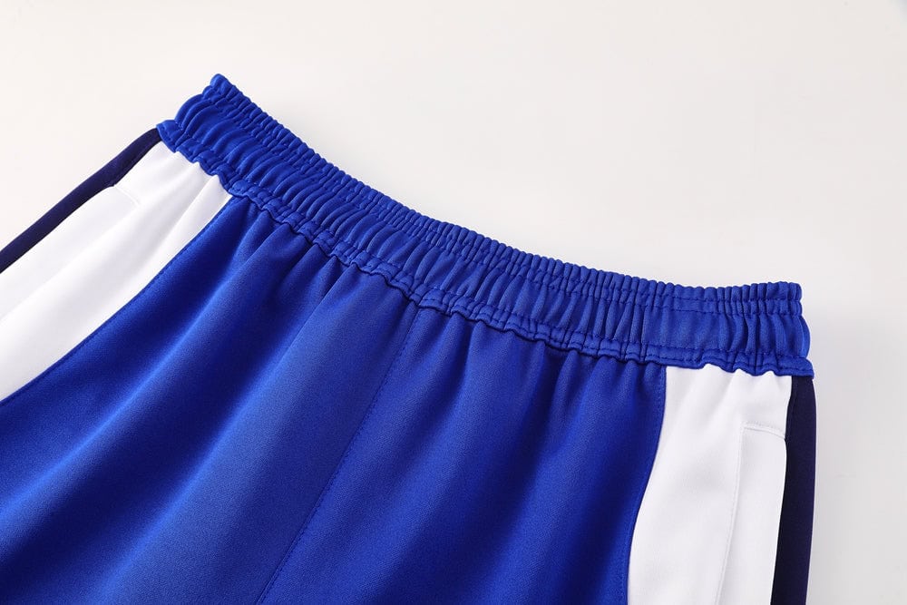 c38d1ab9 | UAE SPORT STORE Close-up of royal blue athletic shorts waistband with white side panels and dark trim.