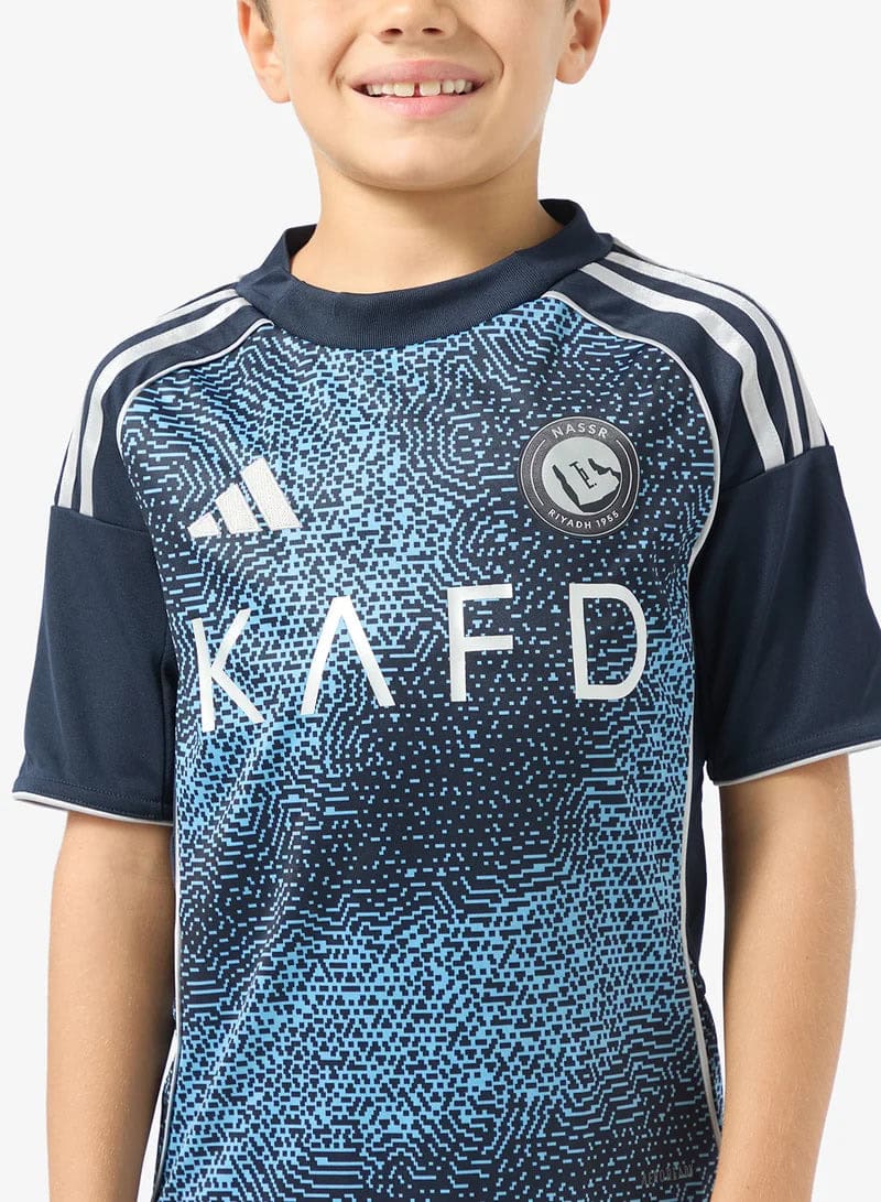 c45e2cbf-01be-4852-b536-ee2b7d4b402f | UAE SPORT STORE Child wearing a navy Adidas sports jersey with a blue pixel pattern and 'KA FD' across the chest, plus a circular team badge on the left chest.
