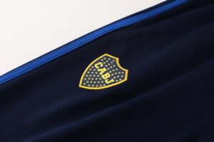 c49d1002 | UAE SPORT STORE Dark navy fabric with a yellow shield logo outlined with stars and the letters CABJ.